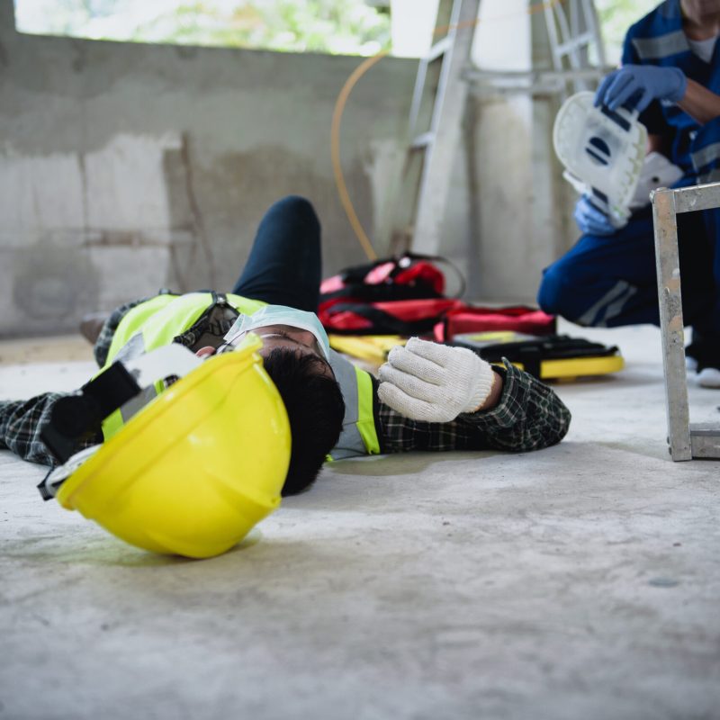 Work accidents of worker in the workplace at construction site area, Builder accident falls ladder on floor and Unconscious, Electric suction, Unsafe concept.
